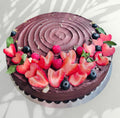 Chocolate fudge cake with strawberry and a blueberry